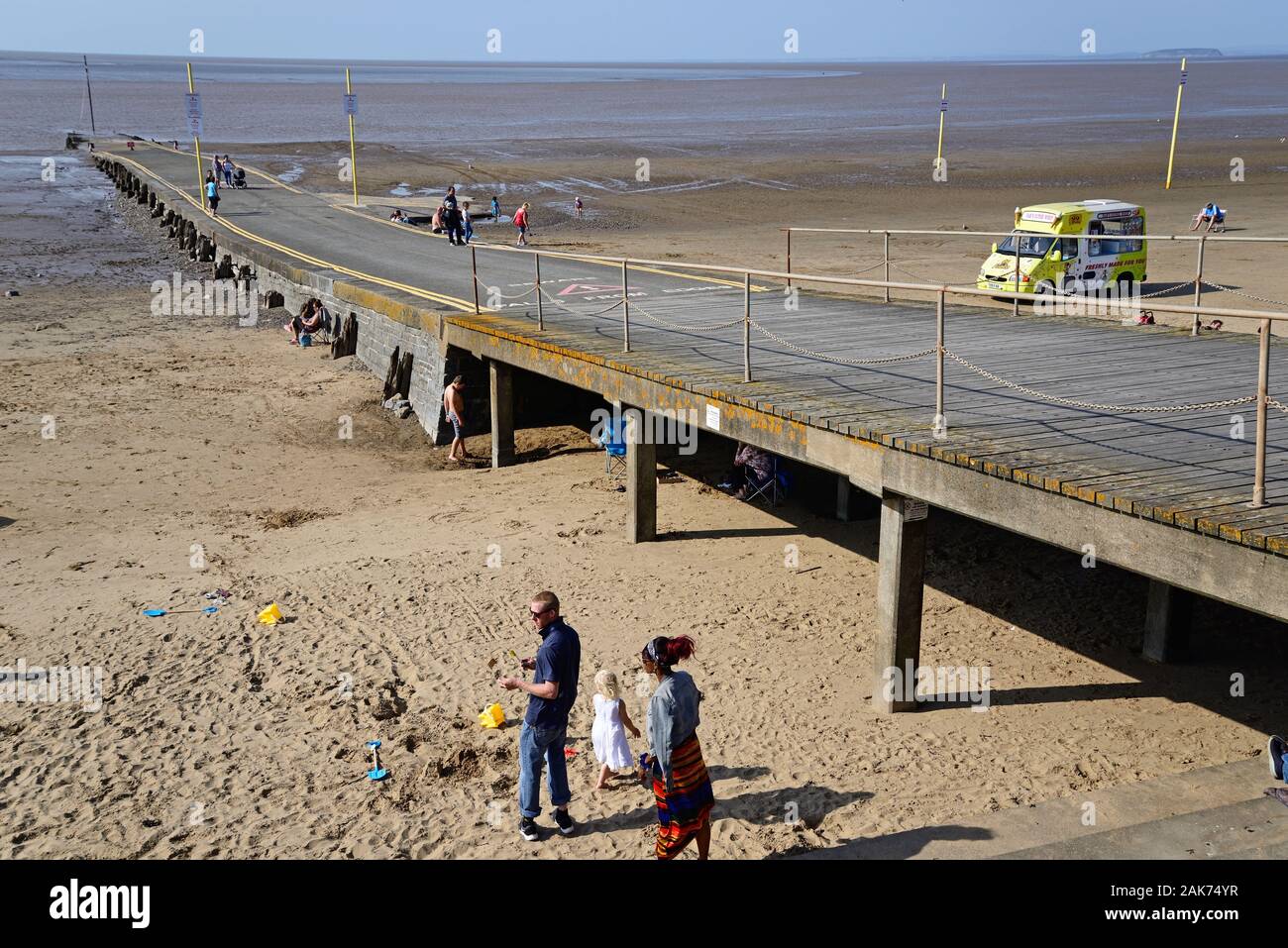Tourists relaxing on the beach with a slipway leading to the sea, Burnham-on-Sea, England, UK. Stock Photo