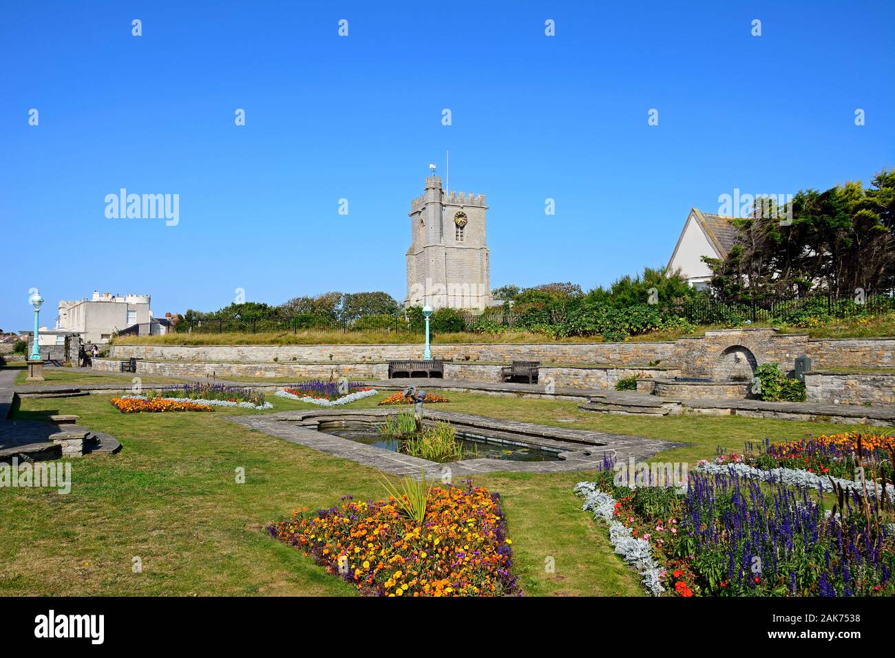 Fountain in the Marine Cove Gardens with St Andrews church to the rear, Burnham-on-Sea, England, UK. Stock Photo