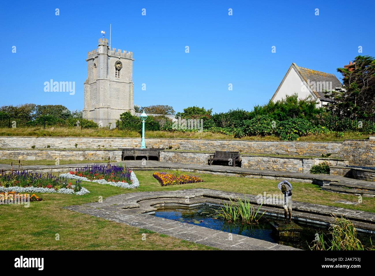 Fountain in the Marine Cove Gardens with St Andrews church to the rear, Burnham-on-Sea, England, UK Stock Photo