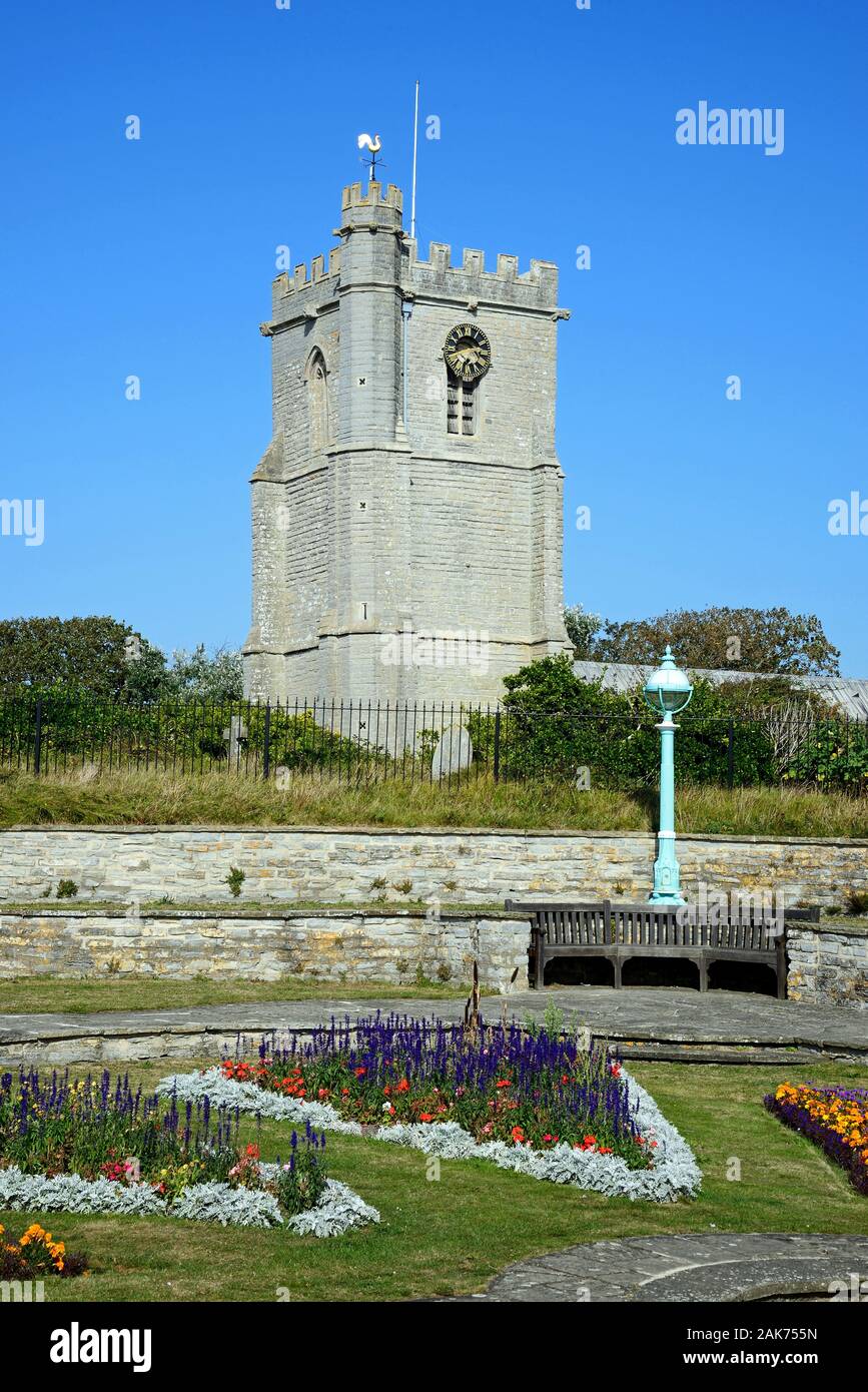 Pretty flowerbeds in Marine Cove Gardens with St Andrews church to the rear, Burnham-on-Sea, England, UK. Stock Photo