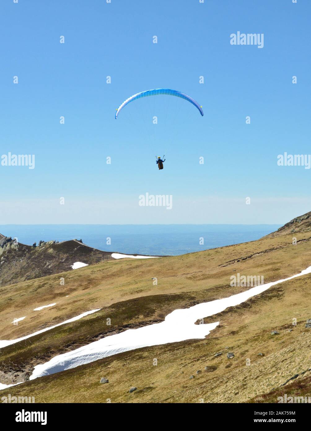 Paraglider flies on top of a volcanic mountain. This is extreme sport Stock Photo