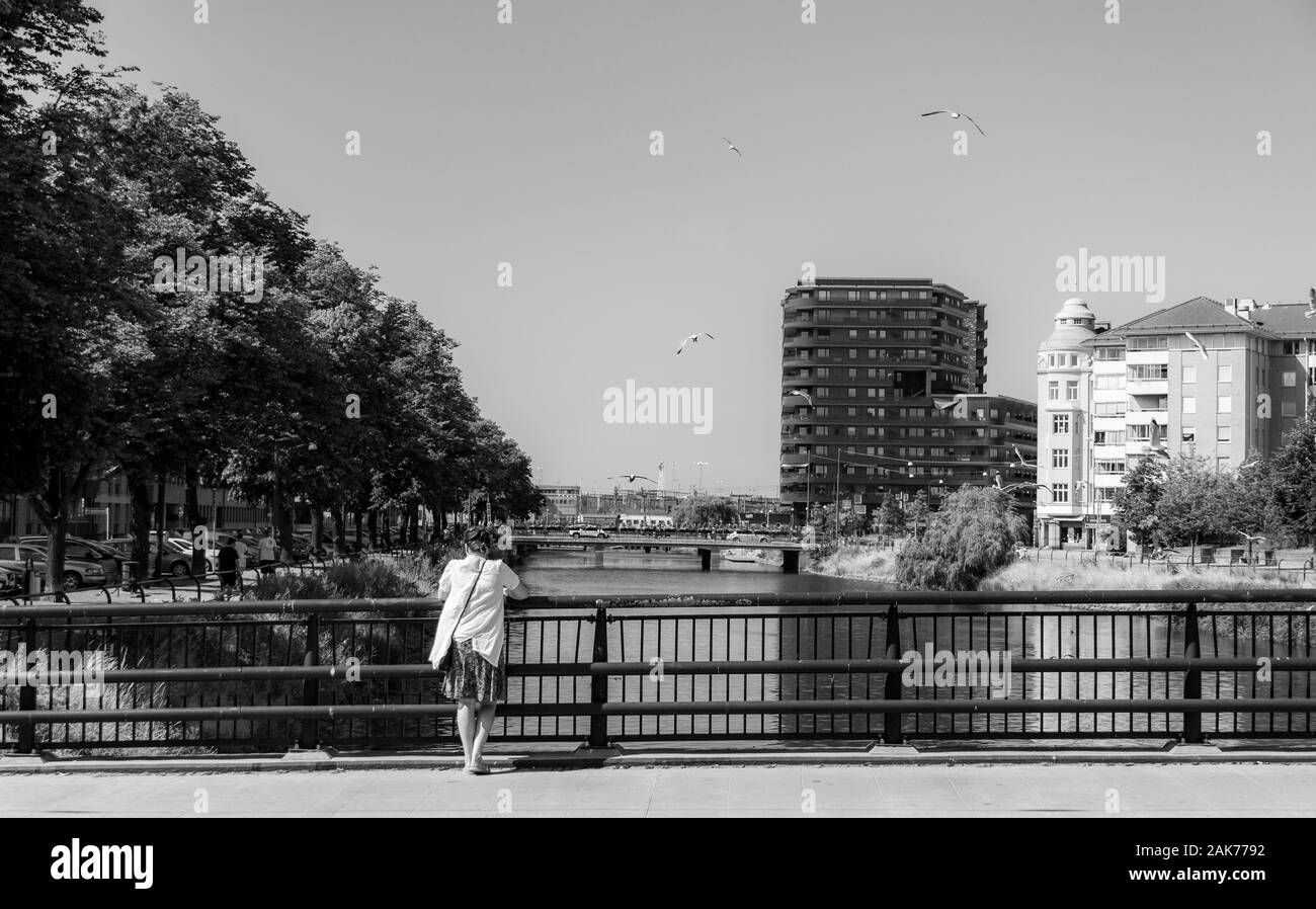 Woman looking over bridge Black and White Stock Photos & Images - Alamy