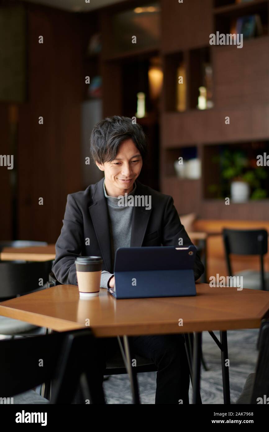 Young Japanese businessman at a cafe Stock Photo