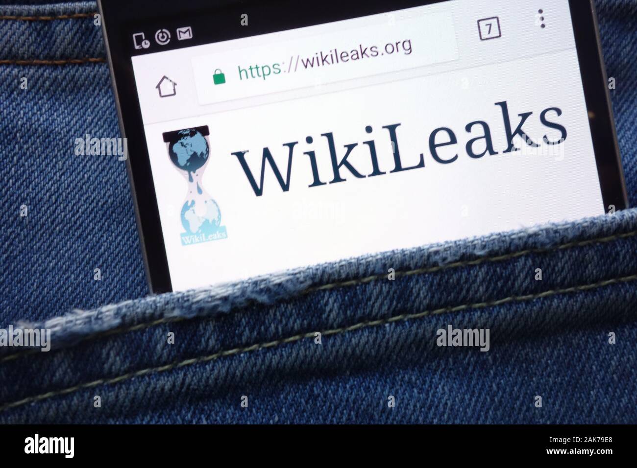 WikiLeaks website displayed on smartphone hidden in jeans pocket Stock Photo
