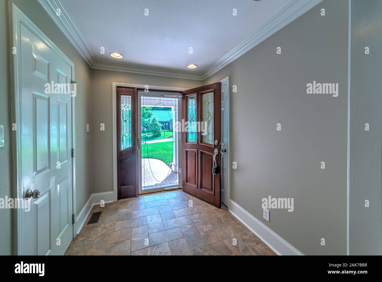 Horizontal shot of the entryway of a home that’s for sale with the realtor box hanging from the front door. Stock Photo