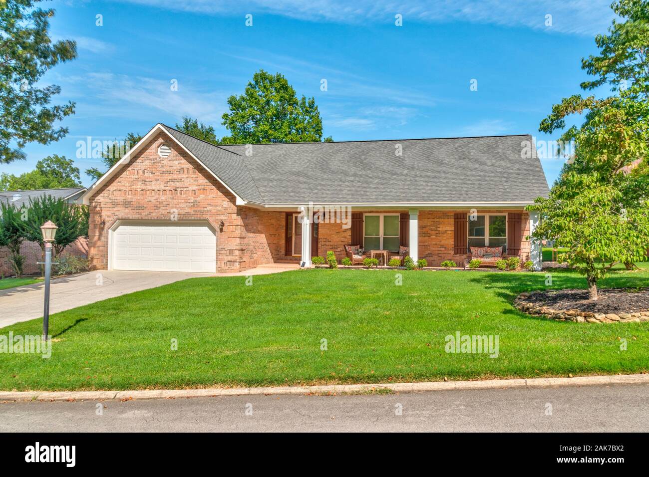 Horizontal shot of a single family home that’s for sale. Stock Photo