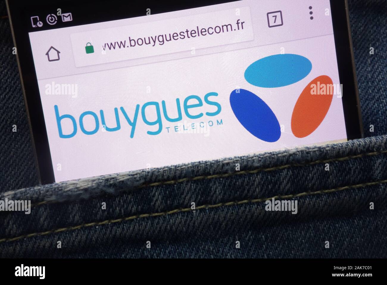 Bouygues Telecom website displayed on smartphone hidden in jeans pocket Stock Photo