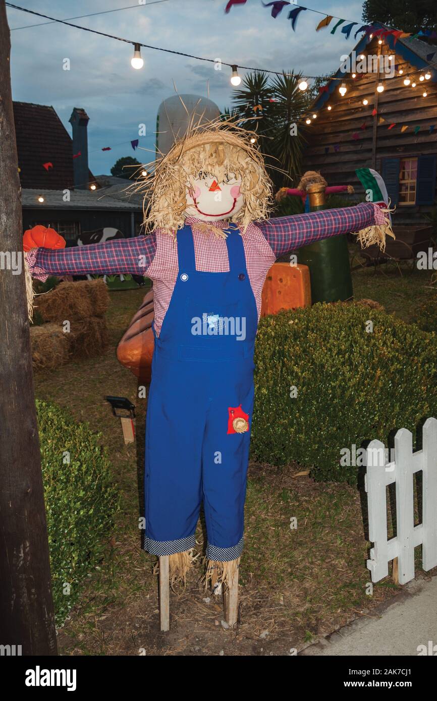 Scarecrow made of colorful clothes in a garden at dusk from a folkloric festival in Canela. A charming small town in southern Brazil. Stock Photo