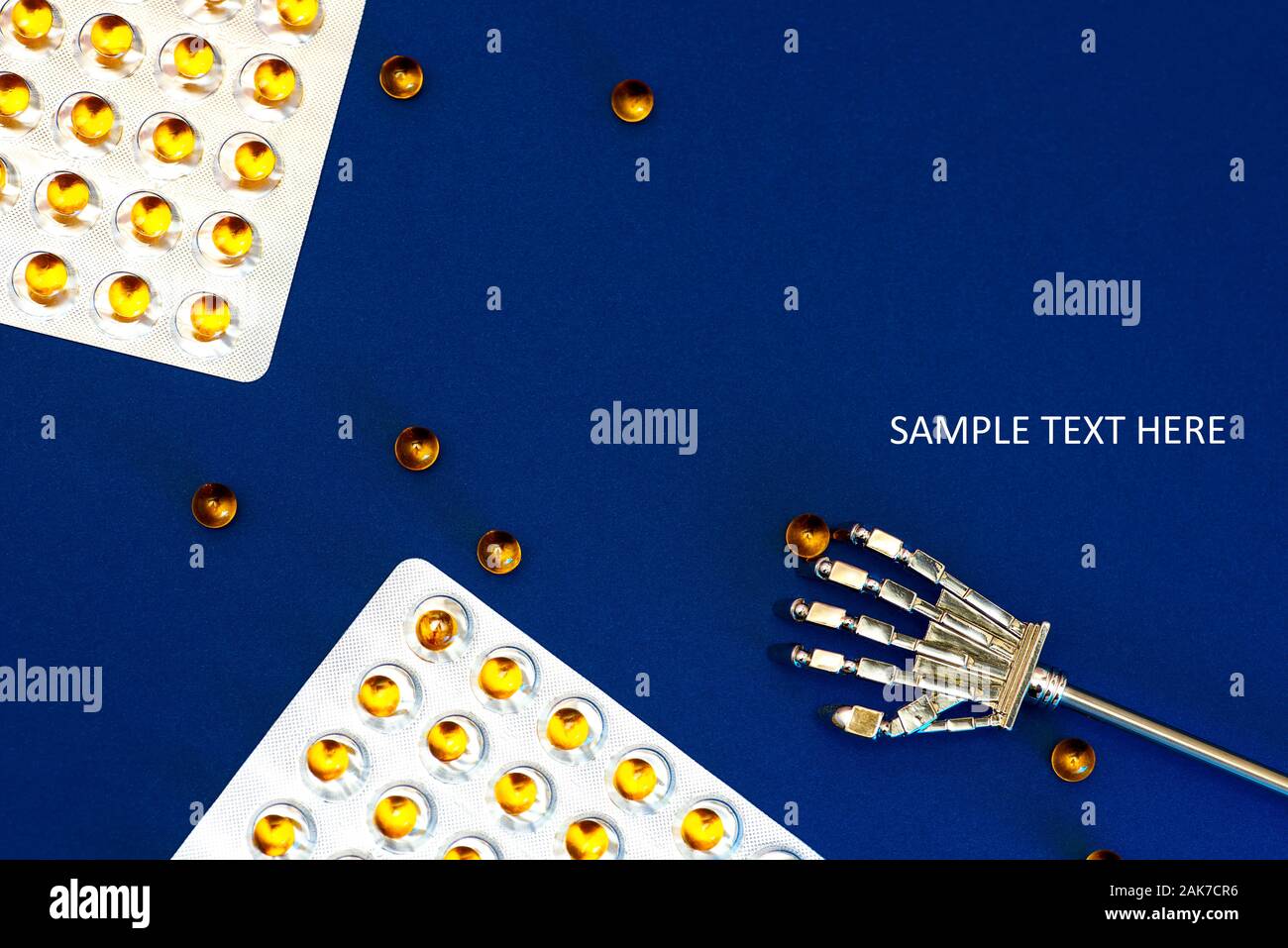 Robot arm and blisters with scattered vitamins with fish oil. Against a