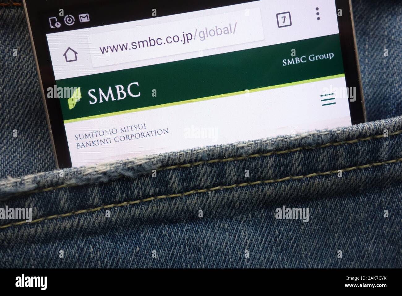 Sumitomo Mitsui Banking Corporation (SMBC) website displayed on smartphone hidden in jeans pocket Stock Photo