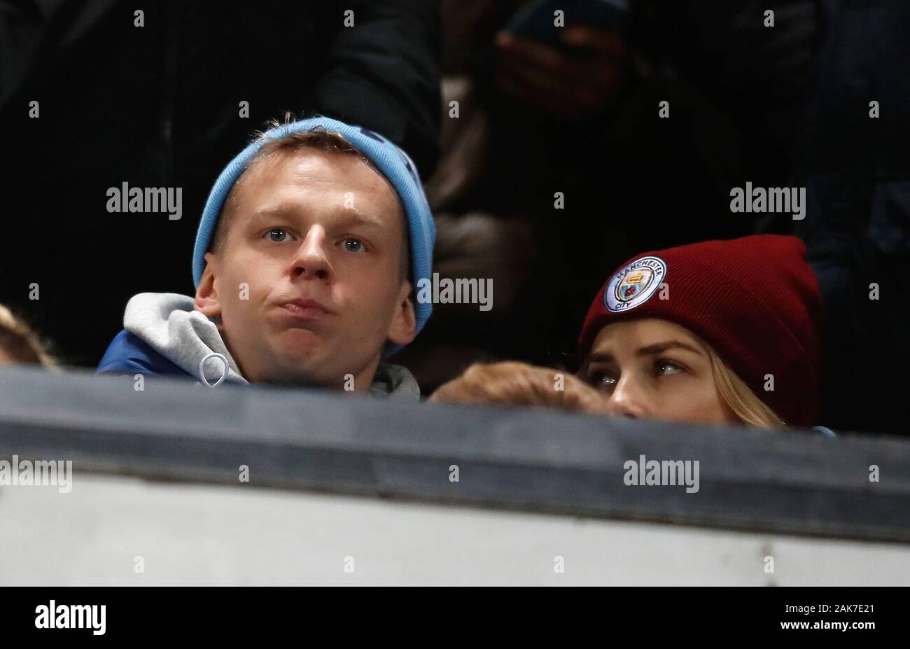 Manchester City's Oleksandr Zinchenko with girlfriend Vlada Sedan in the stands with the Manchester City fans during the Carabao Cup semi final first leg match at Old Trafford, Manchester. Stock Photo