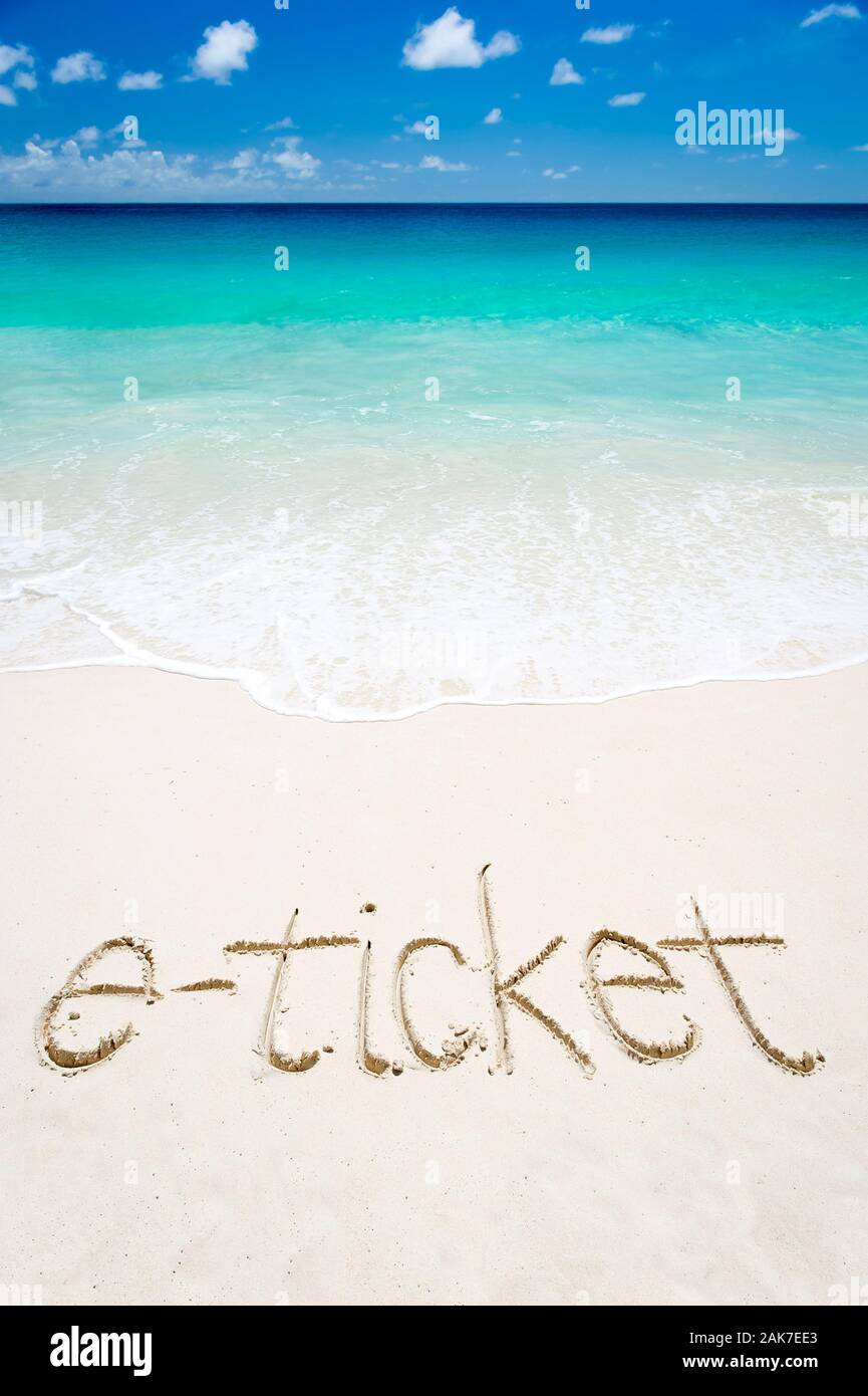 E-ticket to a vacation on a tropical beach with a handwritten message in the sand Stock Photo