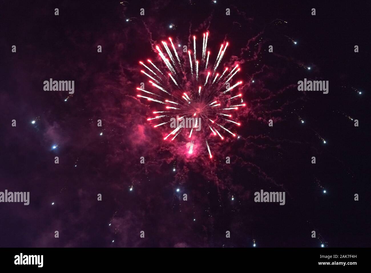 Bright red fireworks against the dark sky. Stock Photo