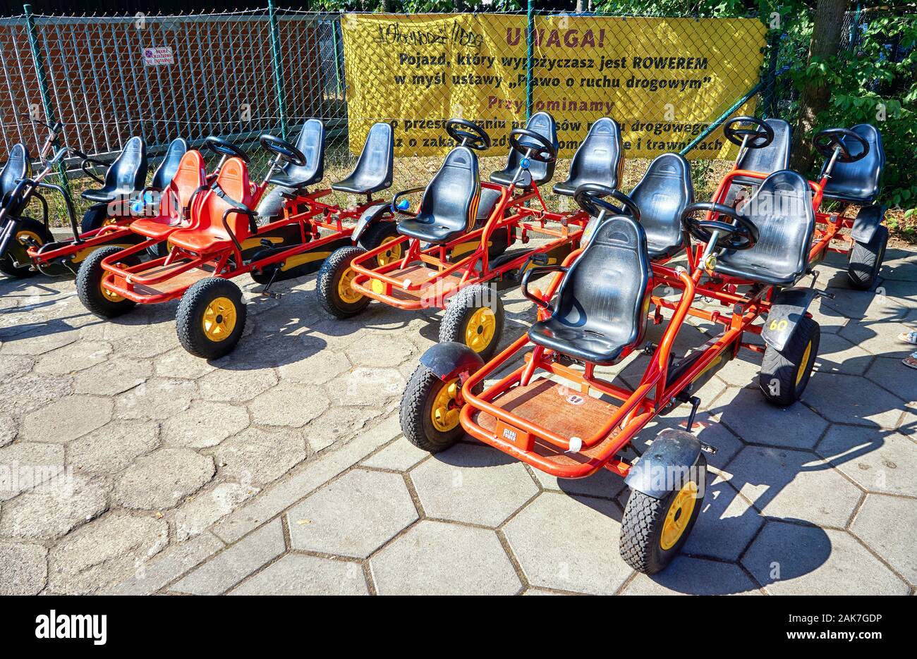 Small pedal go-kart rental cars for children in a row ready for use. Stock Photo