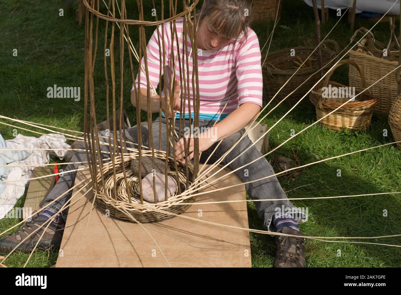 WEAVING with willow (Salix viminalis) OSIER WITHIES. Basket making. Stock Photo