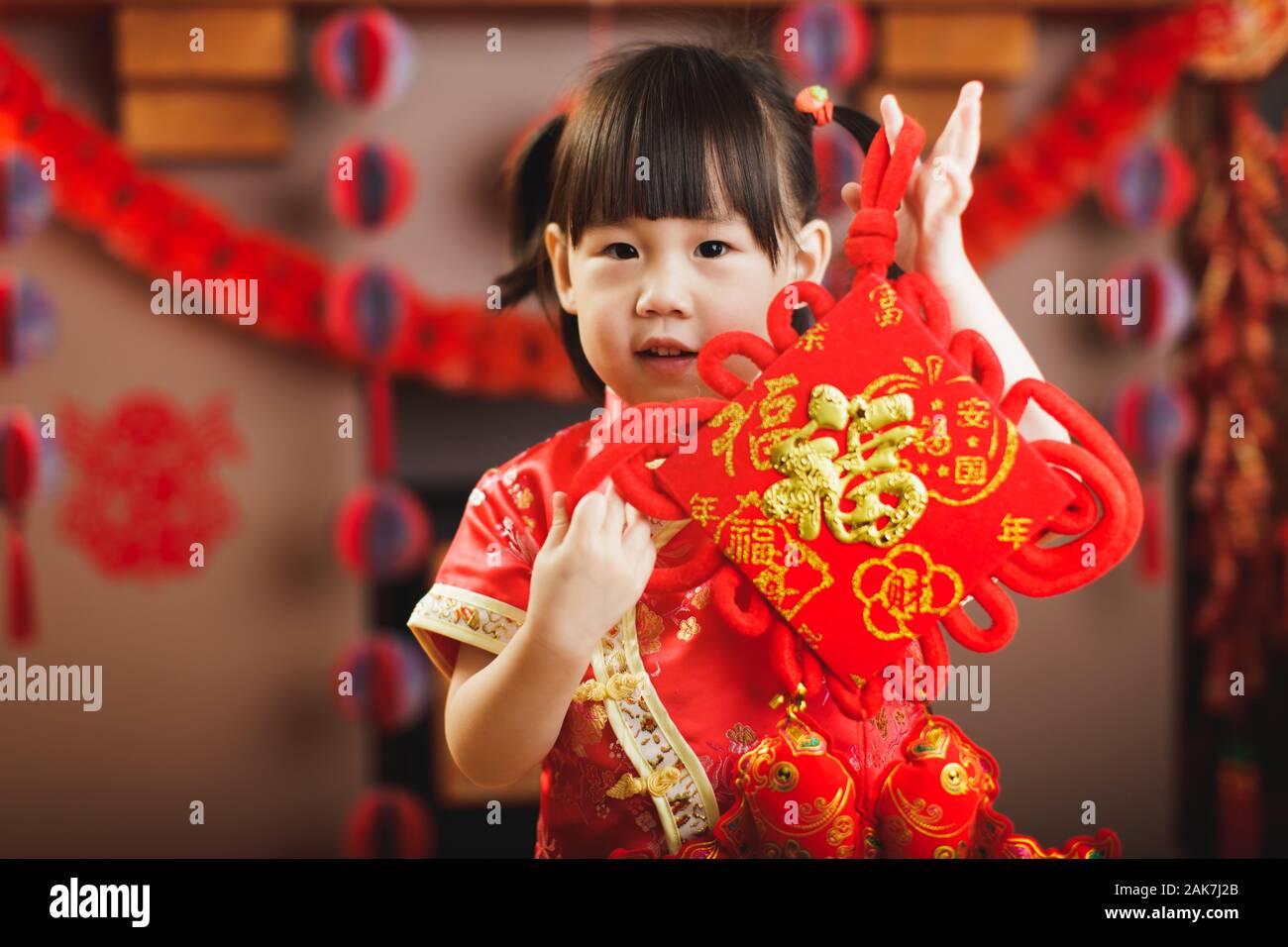 Chinese toddler girl traditional dressing up hold a Fu means 'lucky ...