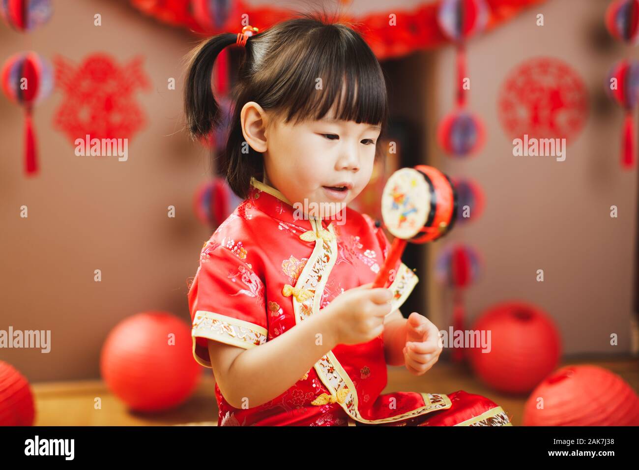 Chinese toddler girl with traditional dressing up celebrate Chinese new ...