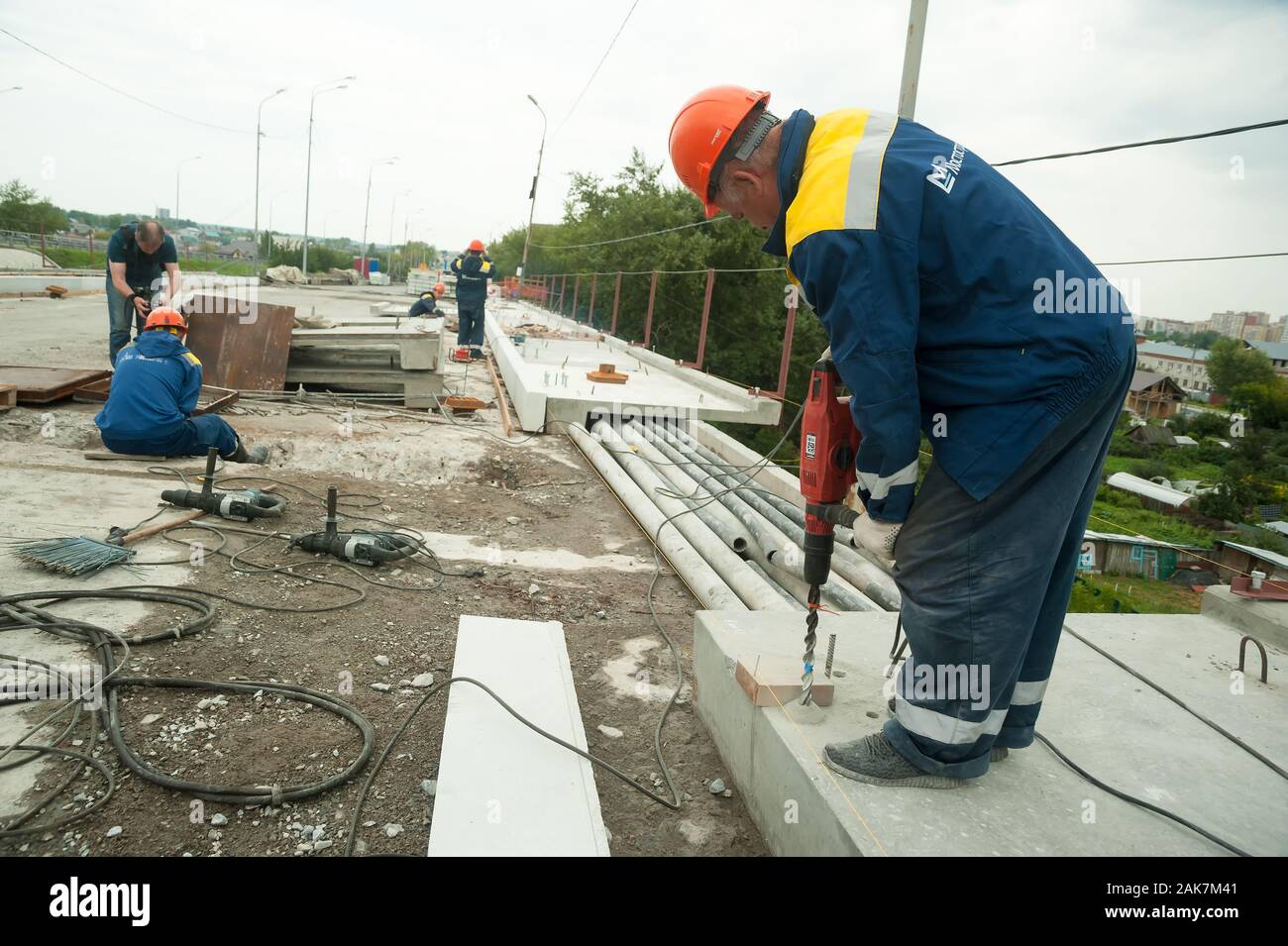 Worker with jackhammer to break up concrete Stock Photo