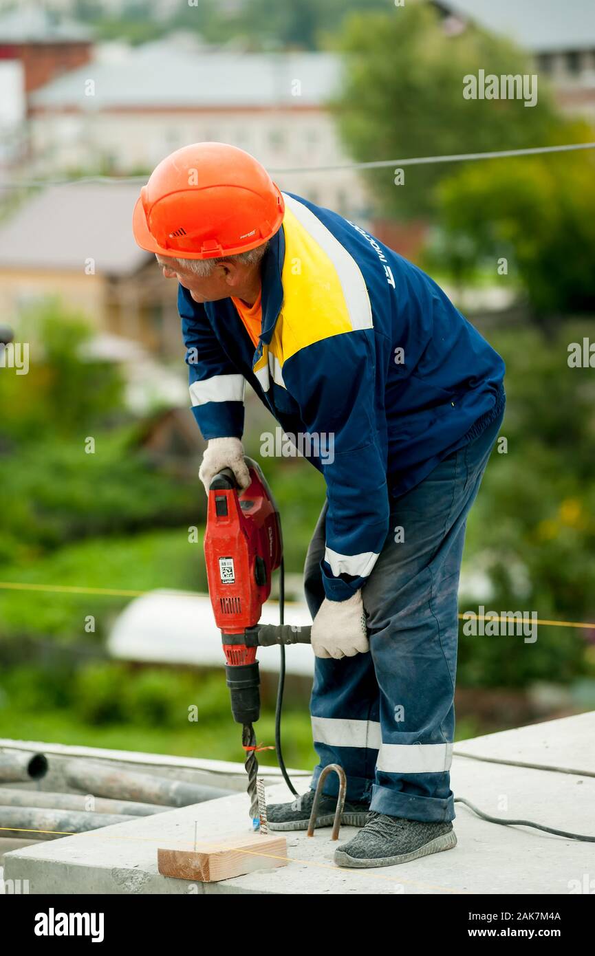 Worker with jackhammer to break up concrete Stock Photo Alamy
