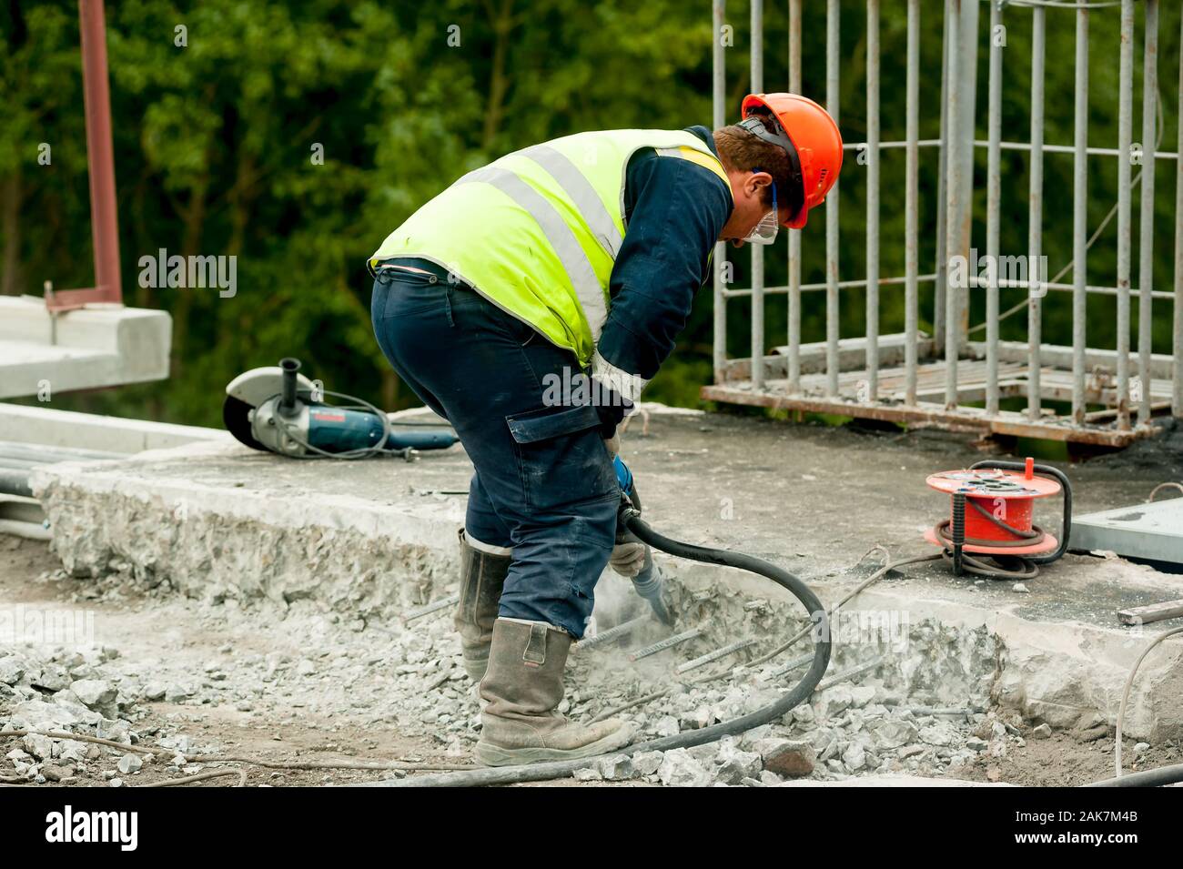 Worker with jackhammer to break up concrete Stock Photo