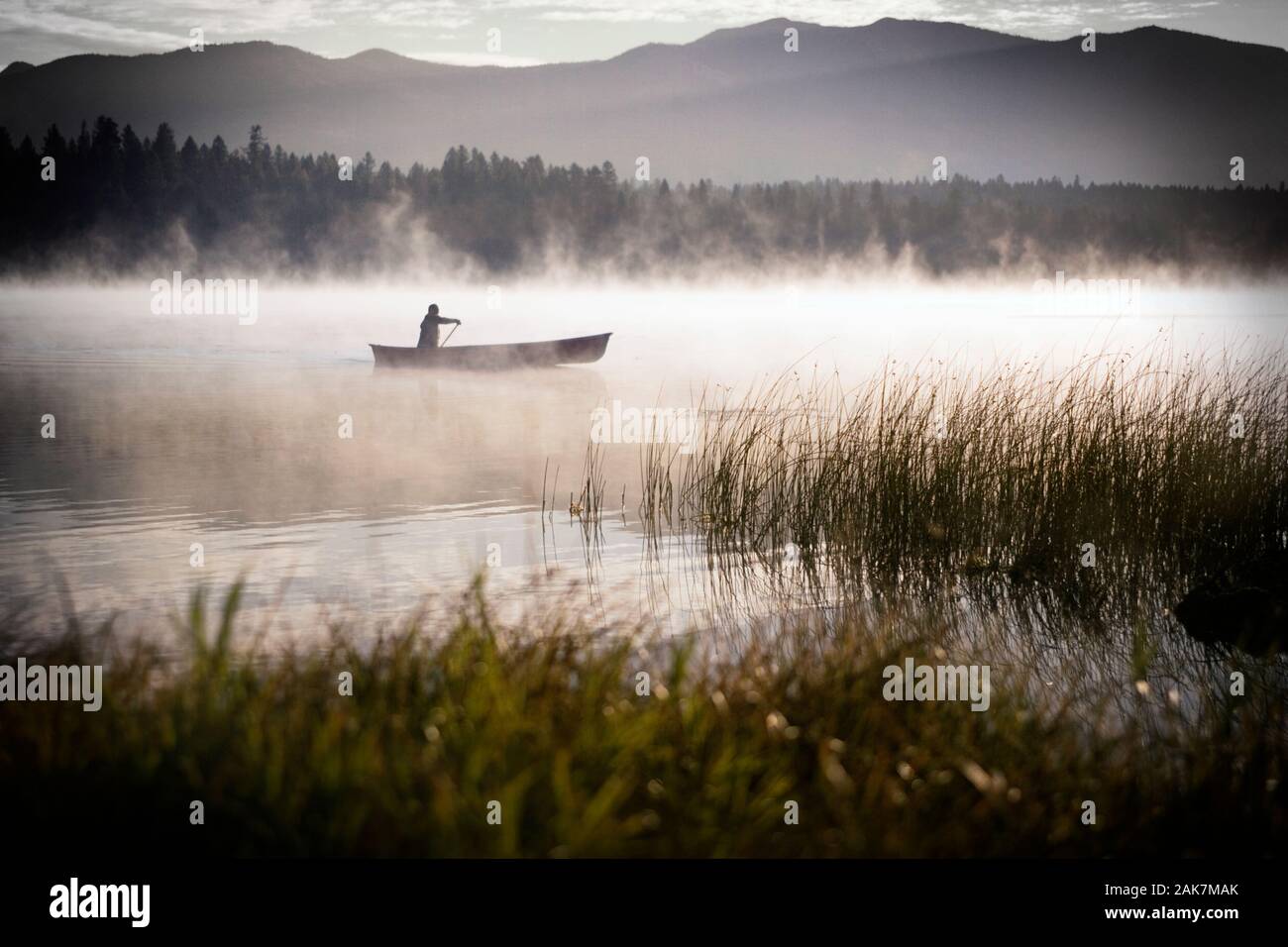 Canoe on lake with fog Stock Photo Alamy