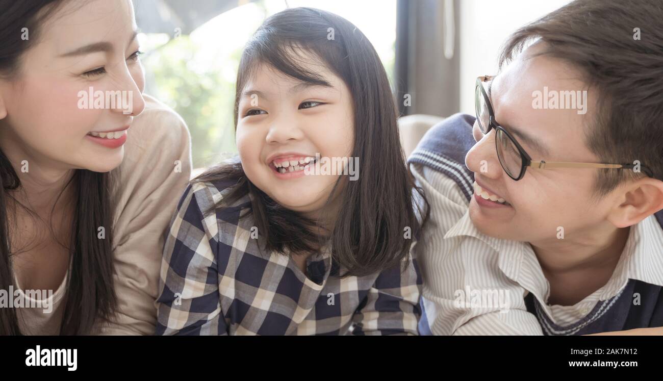 Portrait of happy asian family spending time together in living room. family and home concept Stock Photo
