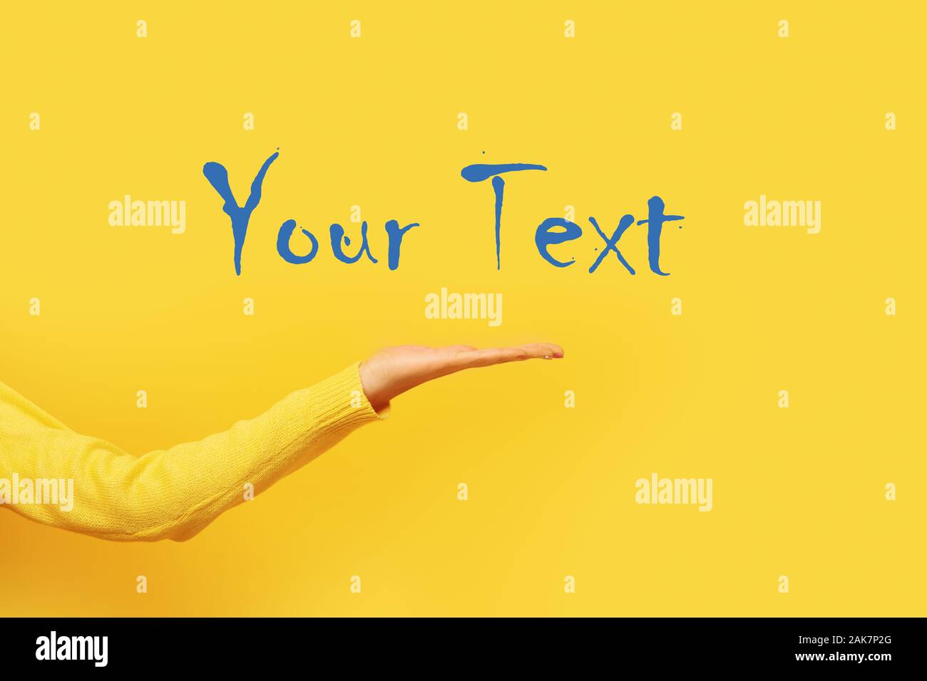 Palm presenting gesture over yellow background, female hand with space for text Stock Photo