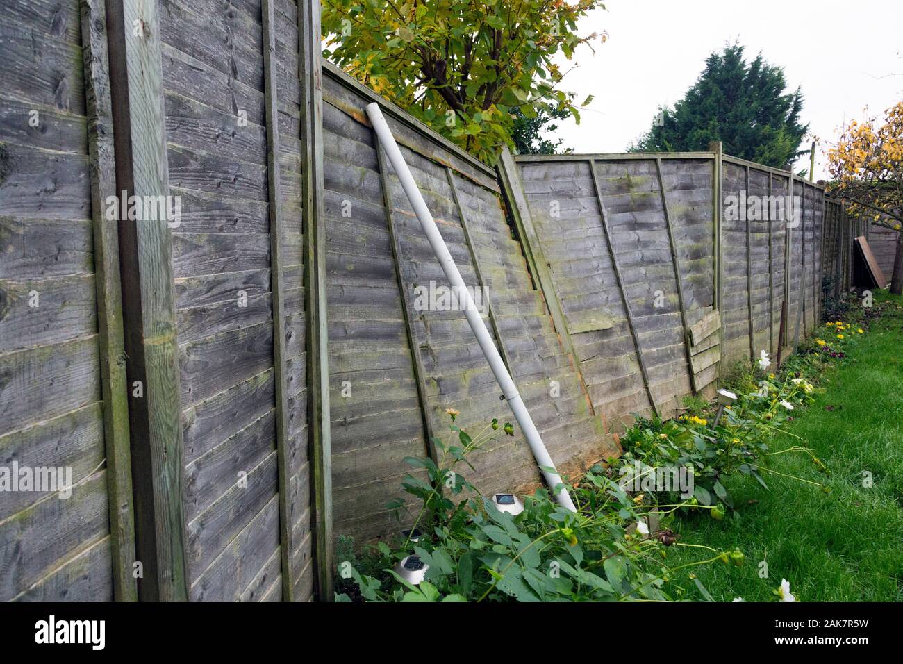 wooden lattice fence damaged by storm weather Stock Photo