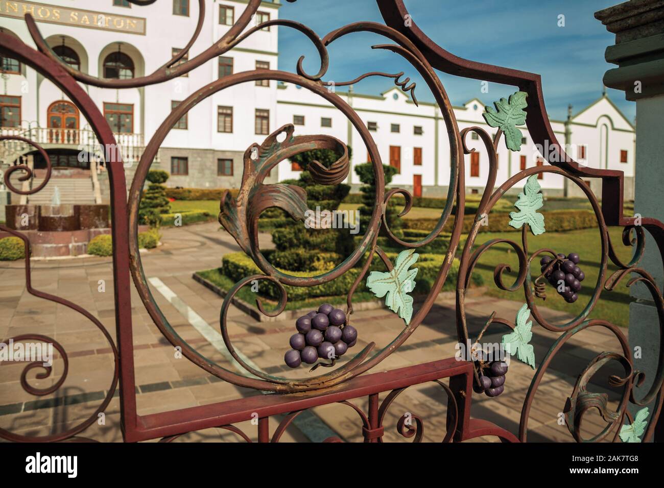 Decorative grapes and vine leaves on iron gate in a winery