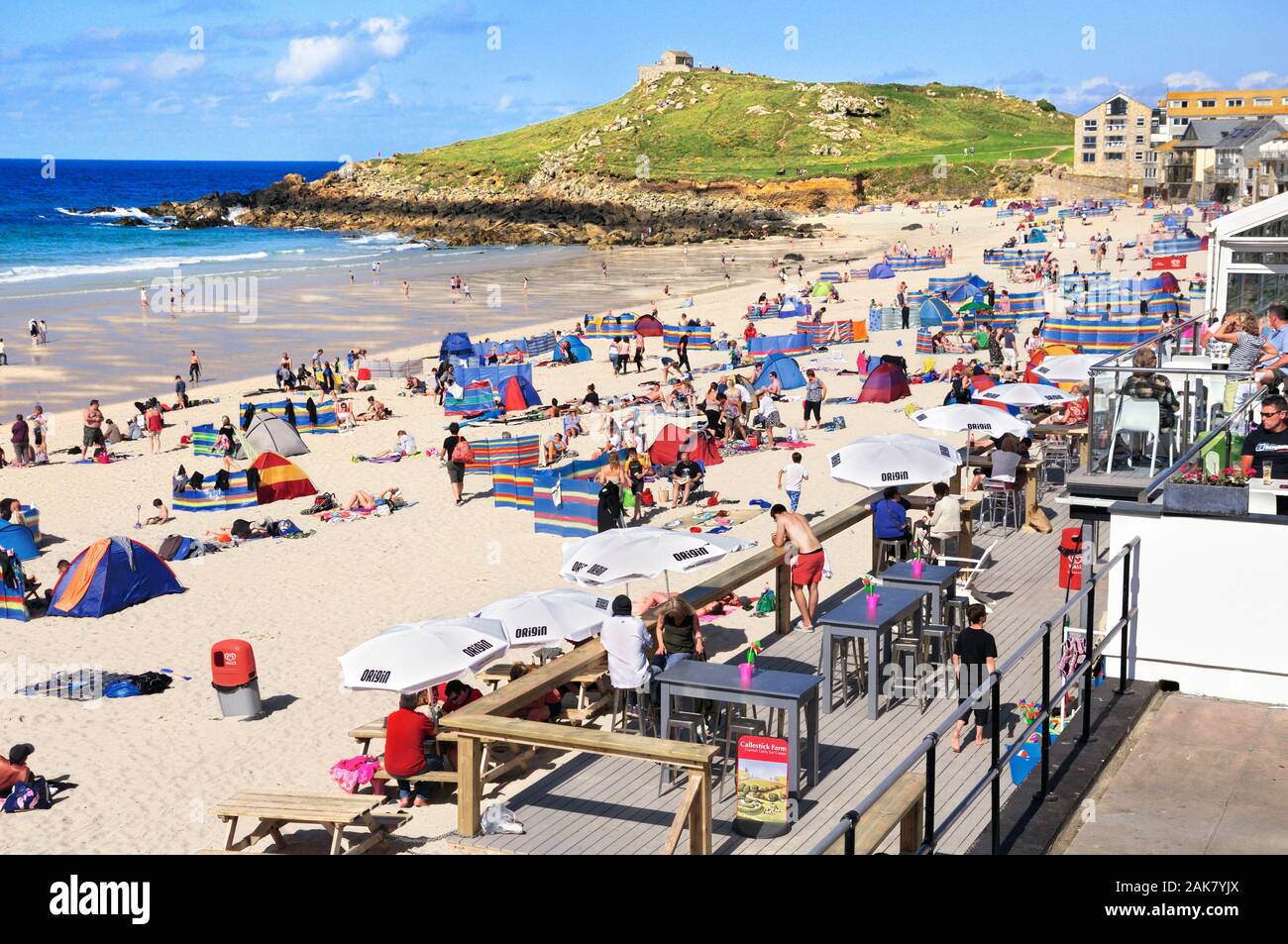 Holidaymakers enjoying the sun on Porthmeor beach in high summer at the popular seaside resort of St Ives in Cornwall, England, UK Stock Photo