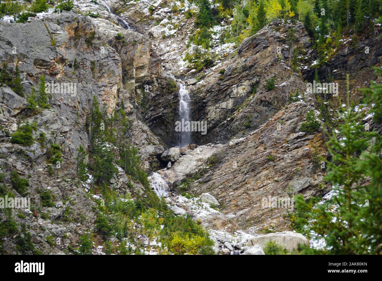 A beautiful waterfall travels down the mountain side in the Teton's Cascade Canyon Stock Photo