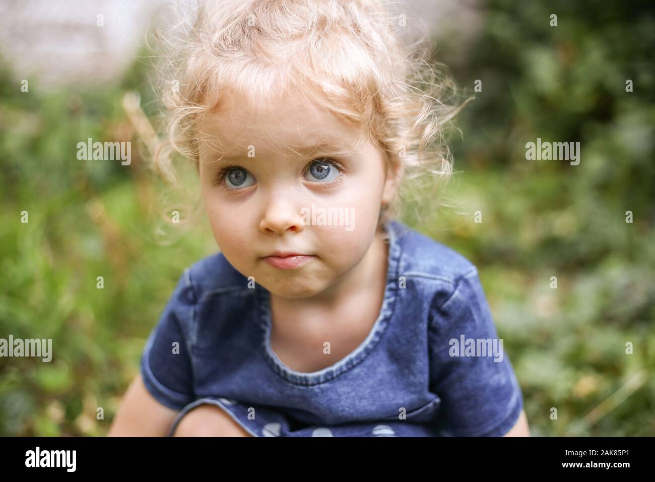 Portrait Of A Little Beautiful European Girl With Curly Blonde
