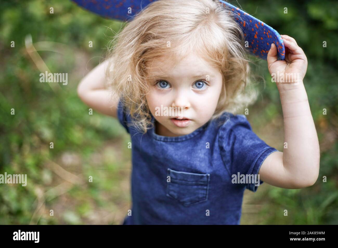 Portrait Of A Little Beautiful European Girl With Curly Blonde