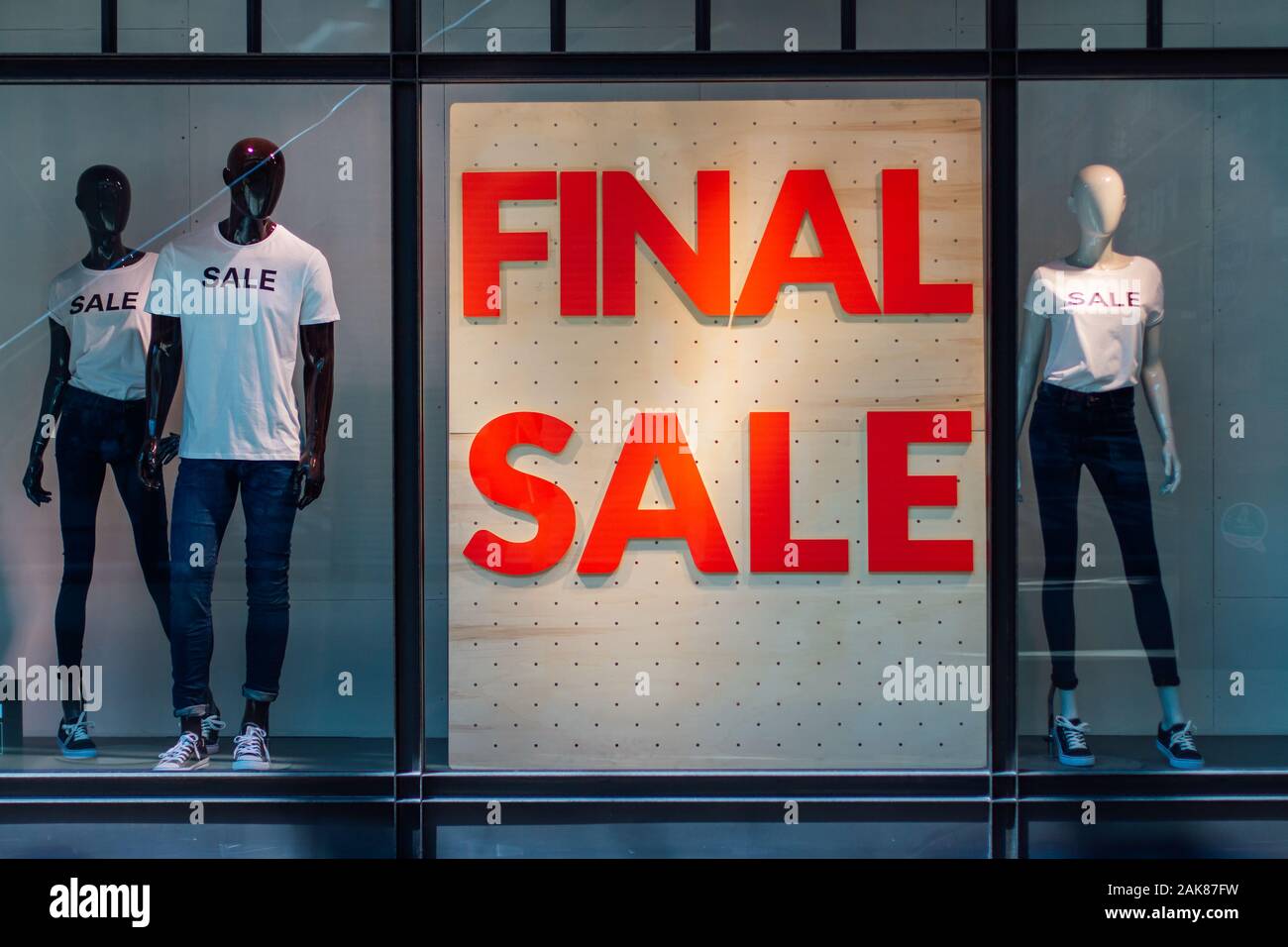 Storefronts with sale sign behind the glass window Stock Photo - Alamy