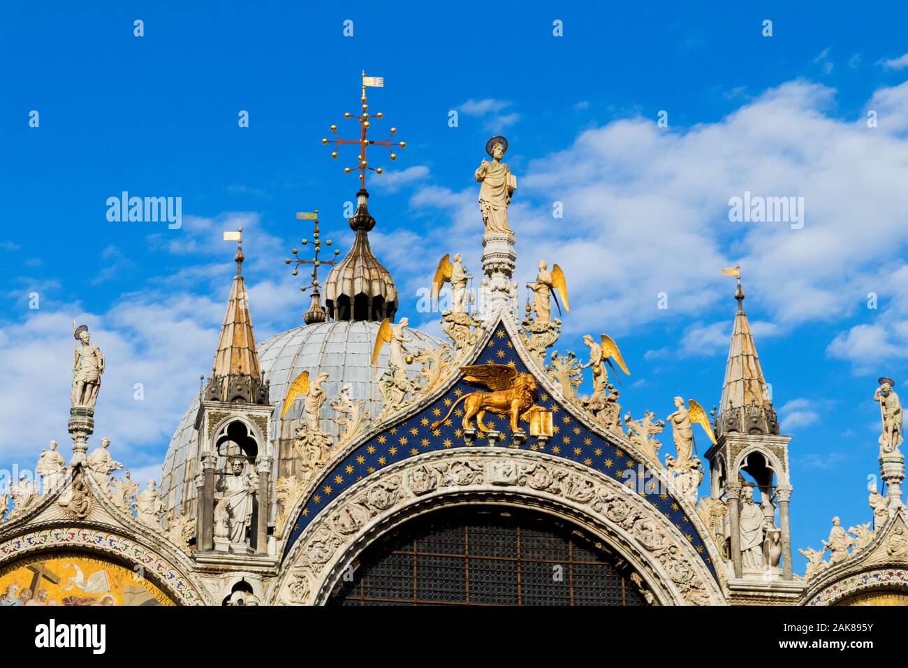 The facade of St Marks Basilica featuring Christ and angels along with the Lion of St Mark in Venice Italy Stock Photo