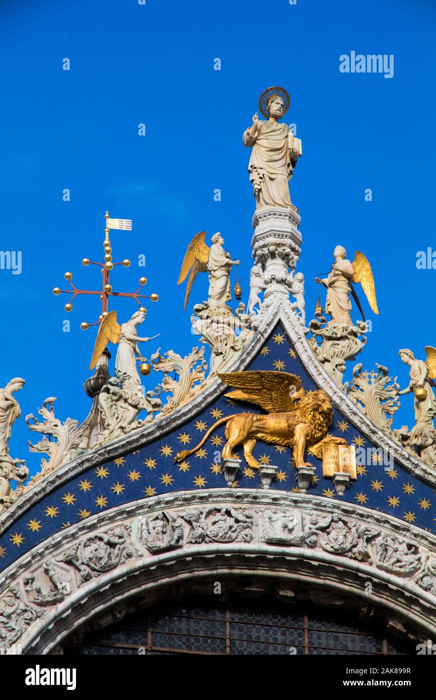 St Marks Basilica featuring ornate gold statues of Christ and angels along with the Lion of St Mark in Venice Italy Stock Photo