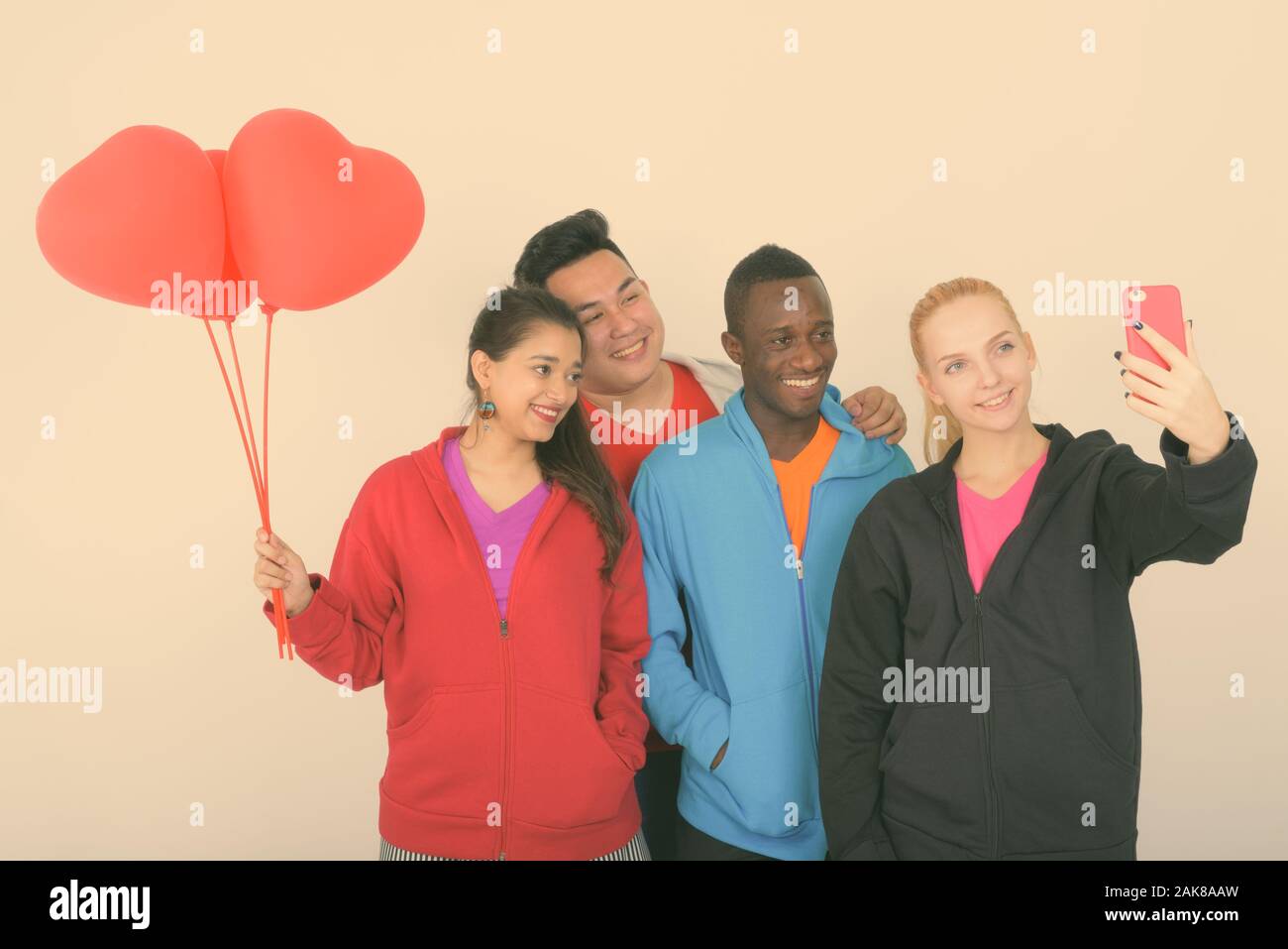 Diverse multi ethnic group of happy friends taking selfie and ready for Valentine's day together Stock Photo