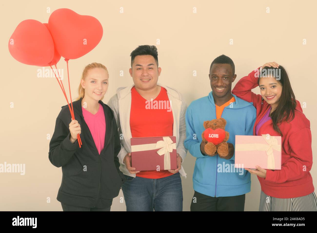 Diverse multi ethnic group of happy friends ready for Valentine's day together Stock Photo