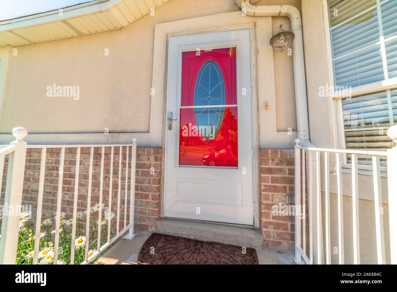 Exterior Of A Home With Decorative Oval Glass Paned Vibrant Red