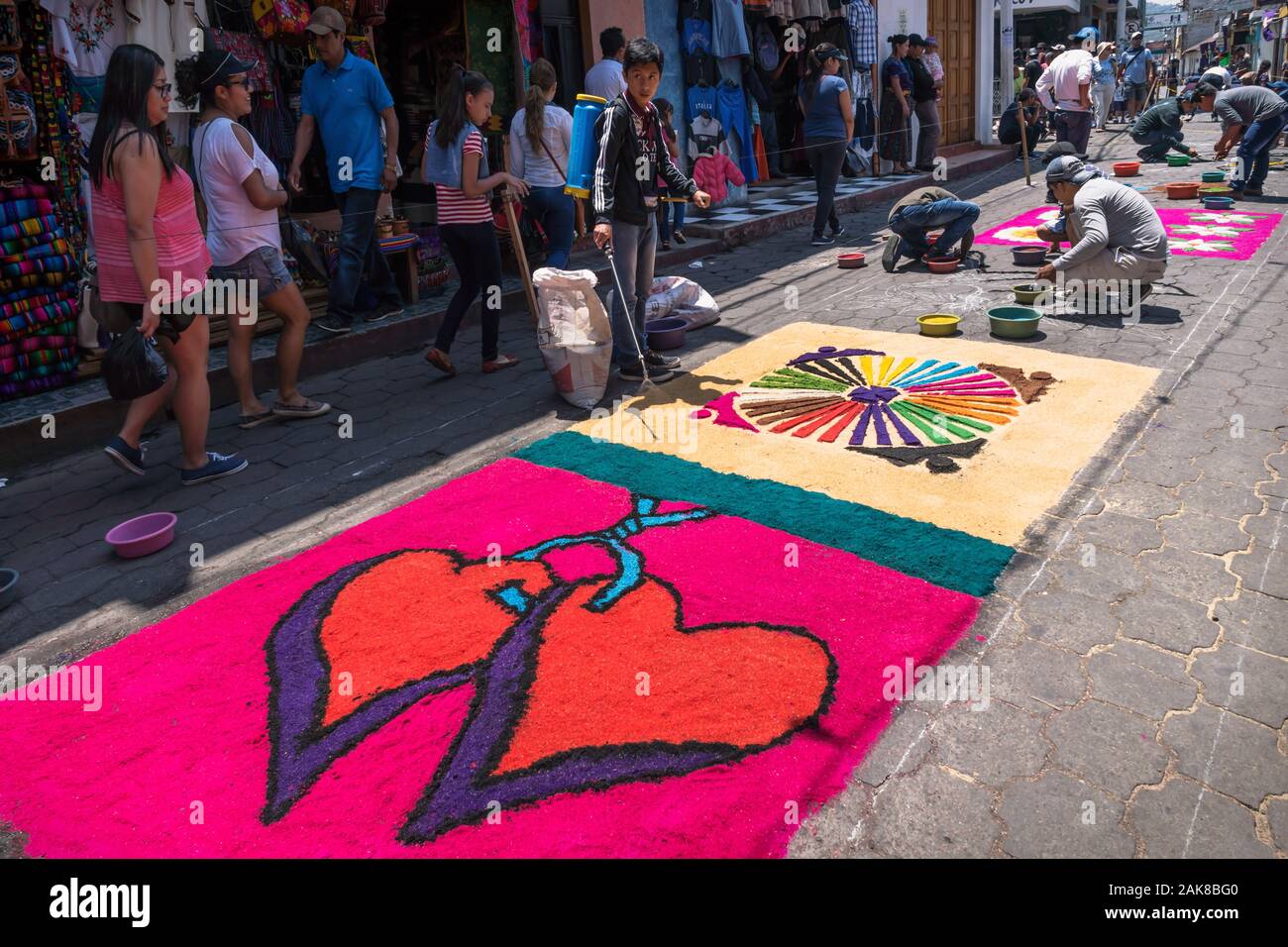 Santiago Atitlan, Guatemala - 30 March 2018: Local people making alfombra, colorful sawdust carpets with hearts for Semana Santa, Easter on the street Stock Photo