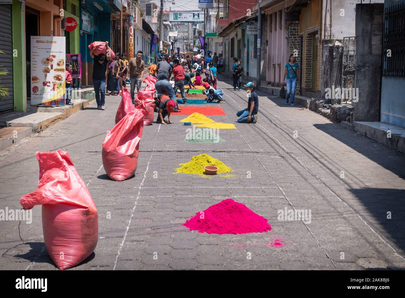 Santiago Atitlan, Guatemala - 30 March 2018: Local people making alfombra from colorful sawdust heaps for Semana Santa, Easter on the street Stock Photo