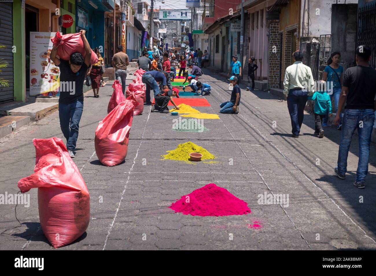Santiago Atitlan, Guatemala - 30 March 2018: Local people making alfombras with colorful sawdust bags for Semana Santa, Easter on the street Stock Photo