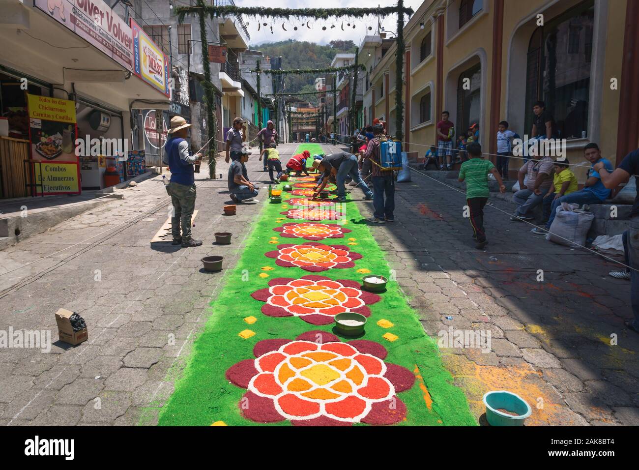 Santiago Atitlan, Guatemala - 30 March 2018: Local people making alfombra, colorful flower sawdust carpets for Semana Santa, Easter on the street Stock Photo