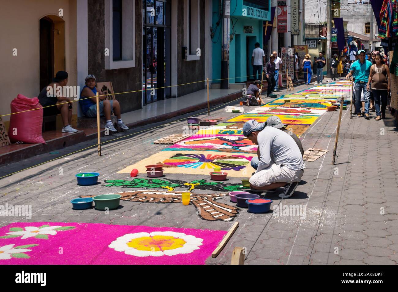 Santiago Atitlan, Guatemala - 30 March 2018: Local boys making alfombra, colorful sawdust carpets for Semana Santa, Easter on the street Stock Photo