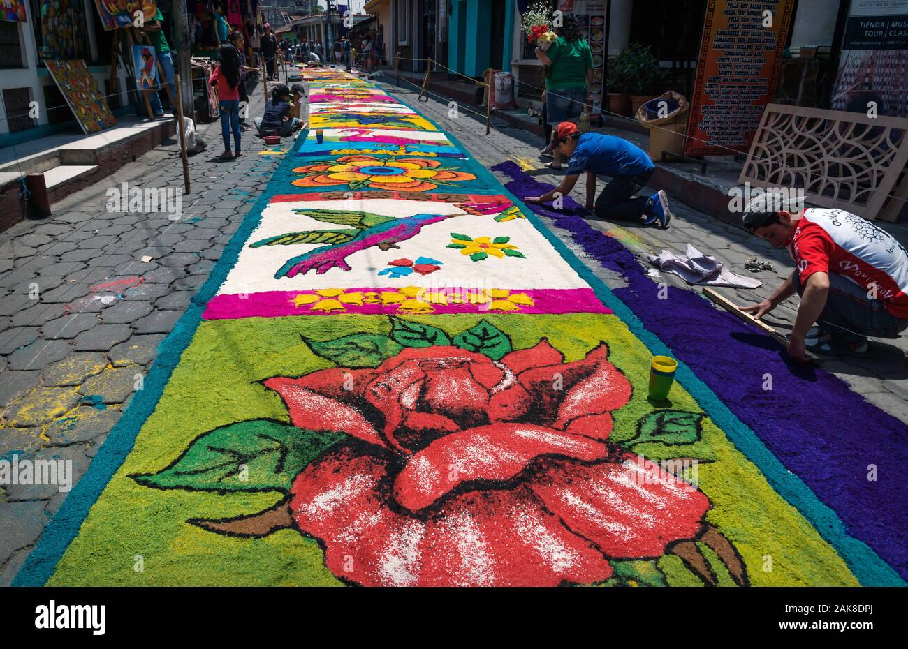 Santiago Atitlan, Guatemala - 30 March 2018: Local people making hummingbird alfombra, colorful sawdust carpets for Semana Santa, Easter on the street Stock Photo