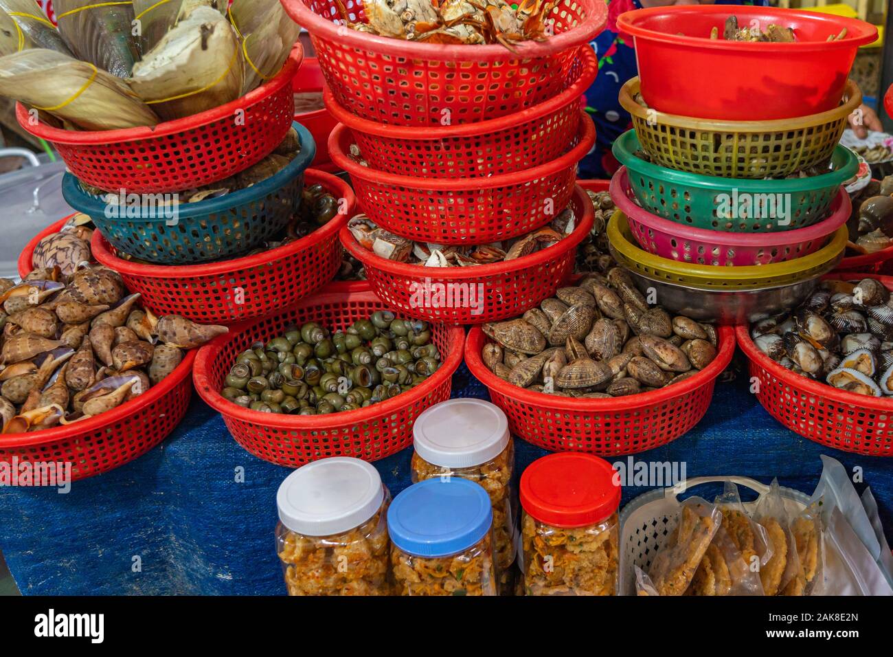 Assortment of snails contained in basket at Asian seafood market Stock Photo