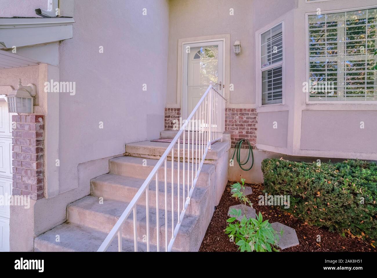 Concrete steps leading to a front door Stock Photo - Alamy