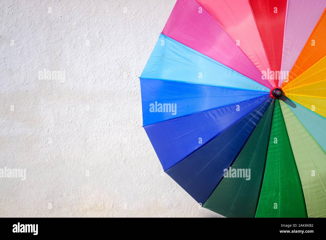Funny colored umbrella isolated on a white background with negative space, for summer. Stock Photo