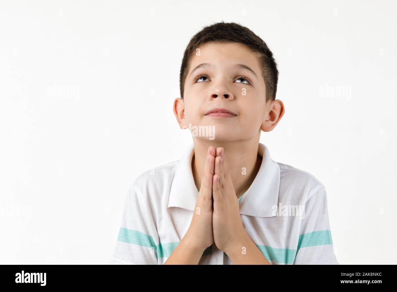 happy little boy in striped tshirt asking for something. Dream come