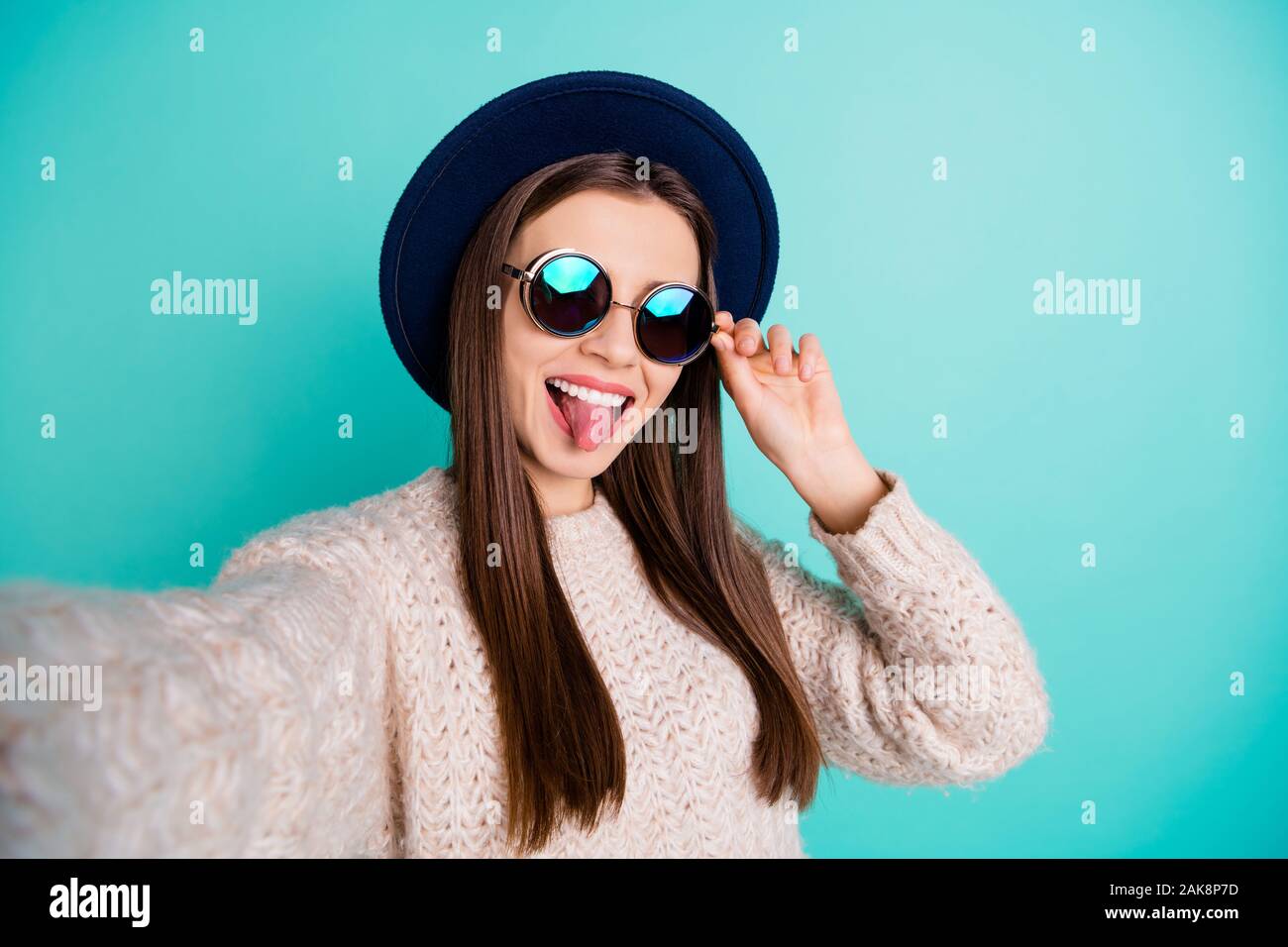 Close up photo of cheerful retro blooger take selfie on her vacation grimace wear knitted sweater isolated over teal turquoise background Stock Photo